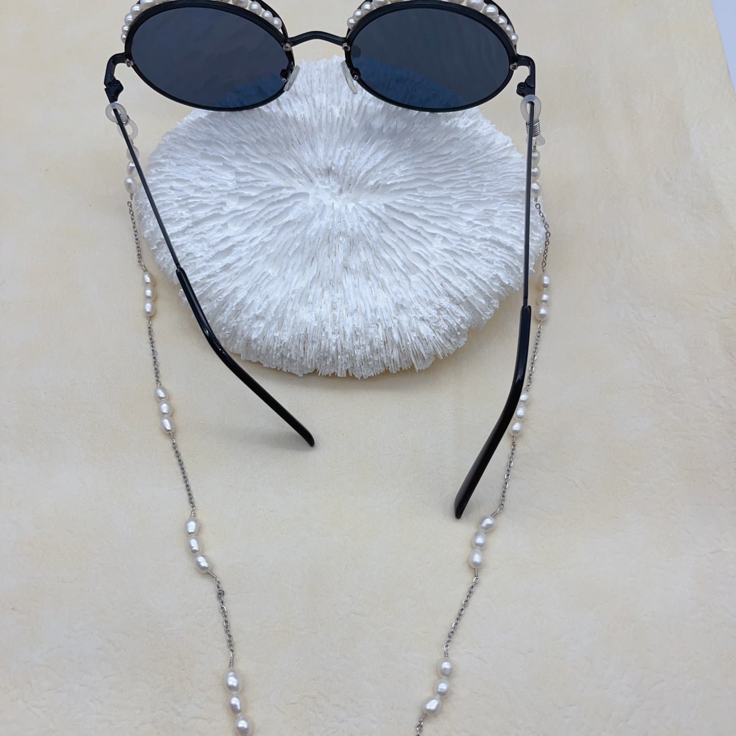 White pearls and black sunglasses