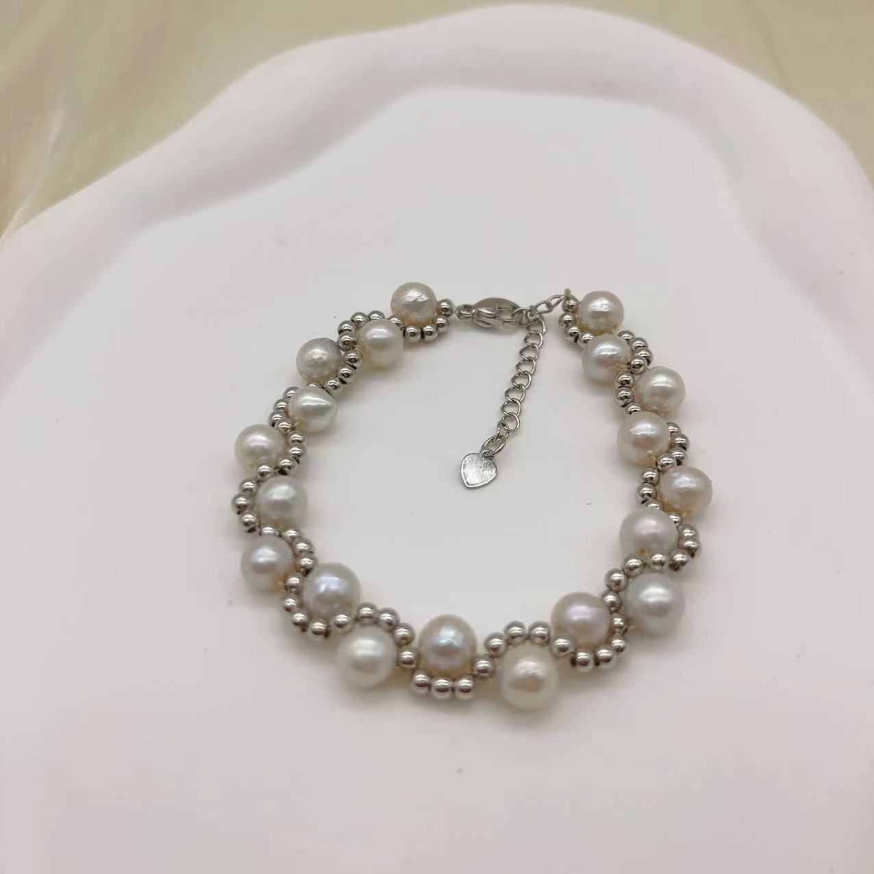 Freshwater pearl strand interwoven with thread bracelet